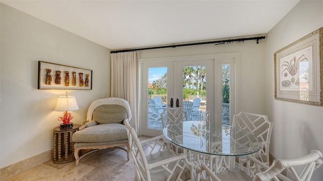 dining space featuring french doors and baseboards