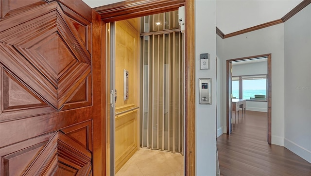 corridor with baseboards and ornamental molding