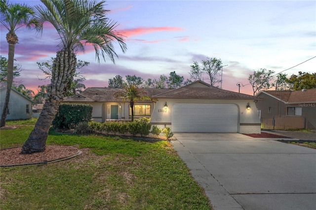 view of front of home featuring brick siding, driveway, an attached garage, and stucco siding