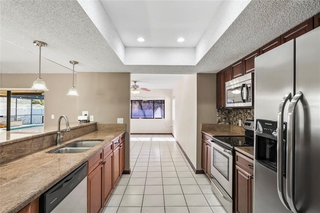 13112 Groveland St, Spring Hill, FL 34609 - kitchen featuring light tile patterned flooring, a sink, appliances with stainless steel finishes, decorative backsplash, and a raised ceiling