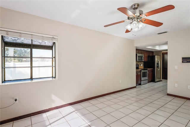 13112 Groveland St, Spring Hill, FL 34609 - spare room with baseboards, visible vents, ceiling fan, and light tile patterned flooring