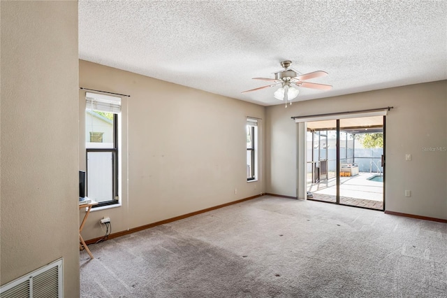 13112 Groveland St, Spring Hill, FL 34609 - spare room with ceiling fan, a textured ceiling, carpet floors, visible vents, and baseboards