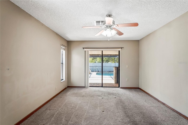 13112 Groveland St, Spring Hill, FL 34609 - spare room with a textured ceiling, carpet floors, visible vents, a ceiling fan, and baseboards