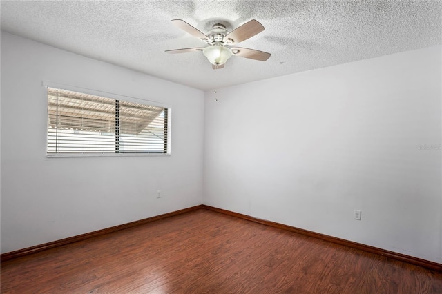 13112 Groveland St, Spring Hill, FL 34609 - empty room featuring a textured ceiling, baseboards, and wood finished floors