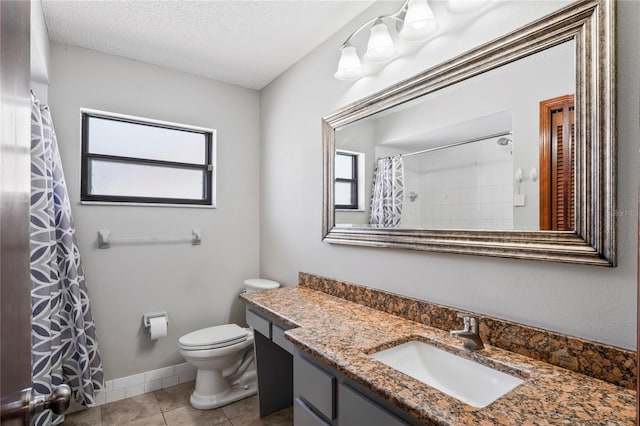 13112 Groveland St, Spring Hill, FL 34609 - bathroom with toilet, vanity, a textured ceiling, baseboards, and tile patterned floors
