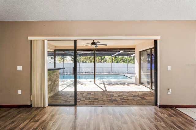13112 Groveland St, Spring Hill, FL 34609 - doorway to outside with a textured ceiling, plenty of natural light, and wood finished floors