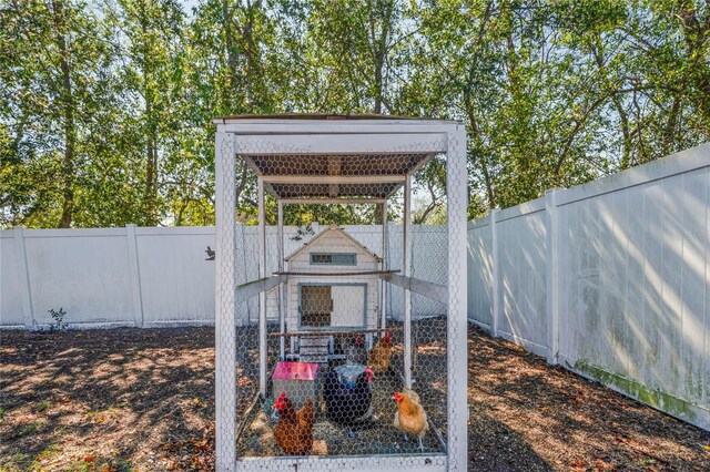 13112 Groveland St, Spring Hill, FL 34609 - view of yard featuring an outbuilding, a fenced backyard, and exterior structure