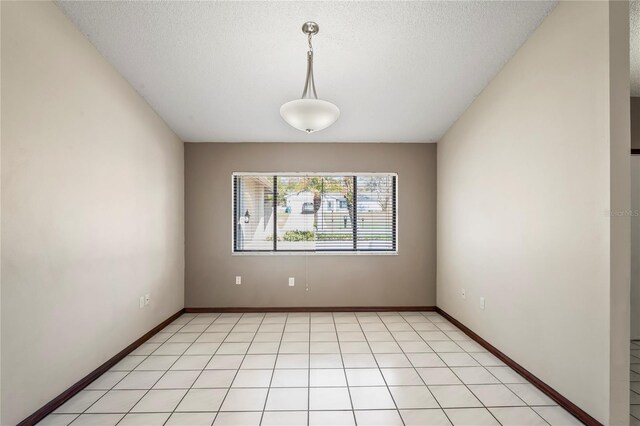 13112 Groveland St, Spring Hill, FL 34609 - spare room with a textured ceiling and baseboards