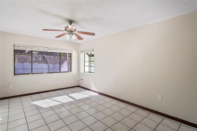 13112 Groveland St, Spring Hill, FL 34609 - empty room featuring light tile patterned floors, baseboards, and a textured ceiling