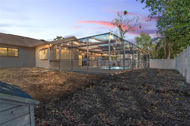 13112 Groveland St, Spring Hill, FL 34609 - back of house with a fenced in pool, glass enclosure, a fenced backyard, a patio area, and stucco siding