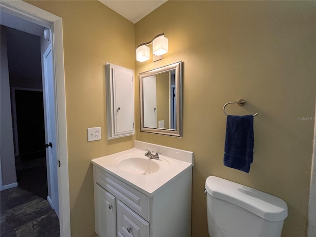 bathroom featuring toilet and vanity