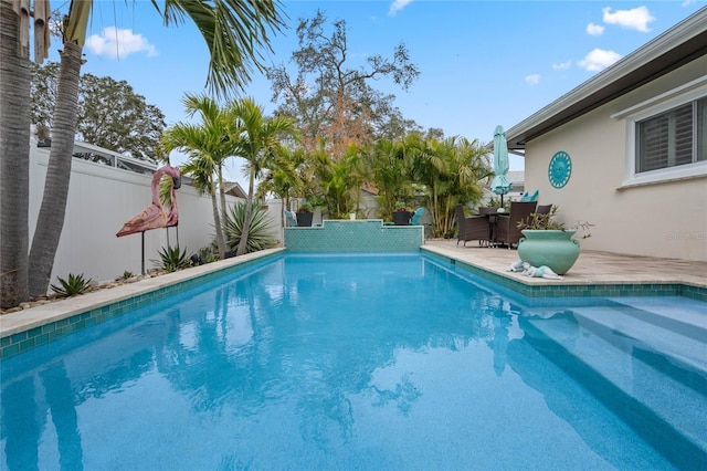 view of pool with a patio area, a fenced backyard, and a fenced in pool