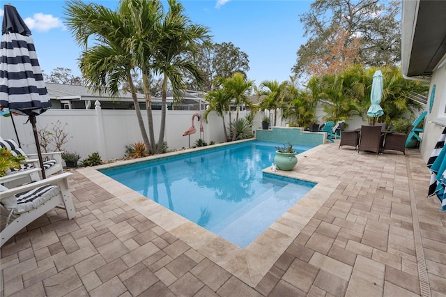 view of swimming pool with a patio area, a fenced backyard, a fenced in pool, and outdoor dining space