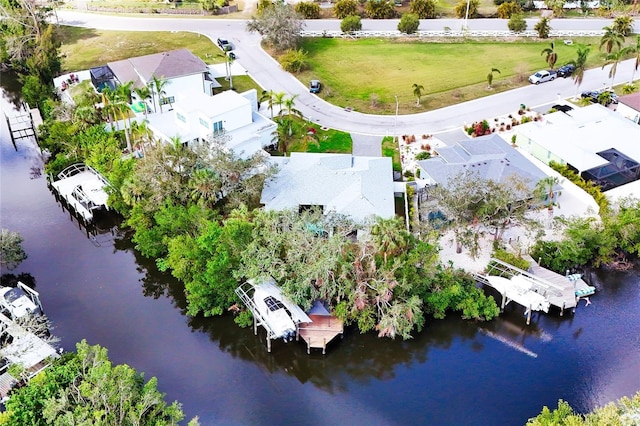 drone / aerial view featuring a water view and a residential view