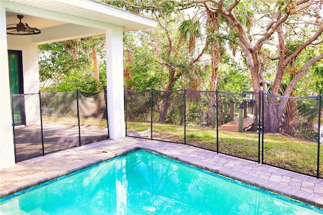 view of swimming pool with a patio area, ceiling fan, fence, and a fenced in pool