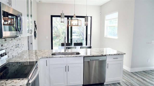 kitchen featuring appliances with stainless steel finishes, a sink, and white cabinetry