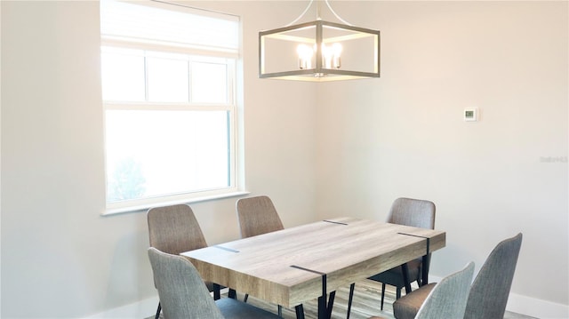 dining room with baseboards and an inviting chandelier