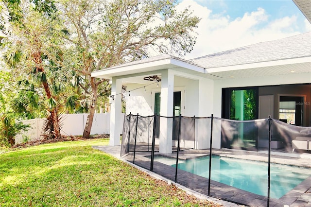 view of pool with a yard, a patio, fence, and a fenced in pool