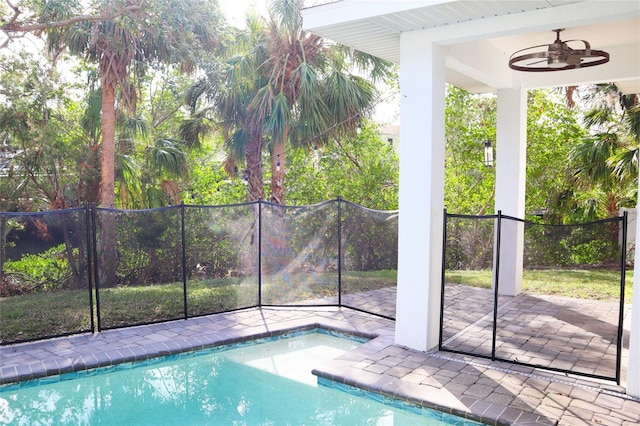 view of pool featuring a ceiling fan, a fenced in pool, a patio area, and fence