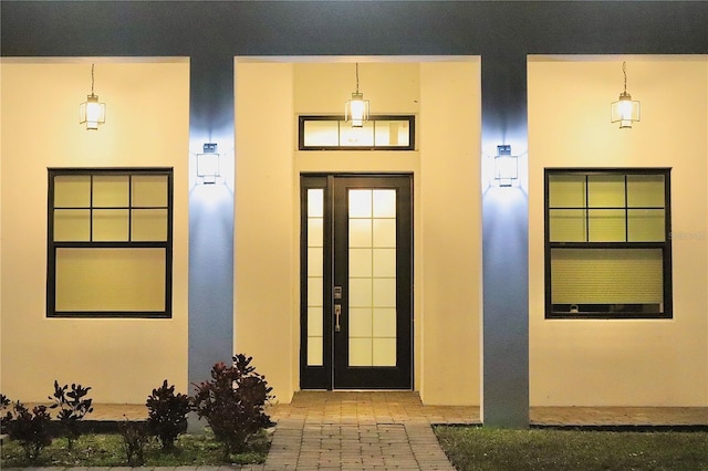 property entrance featuring stucco siding