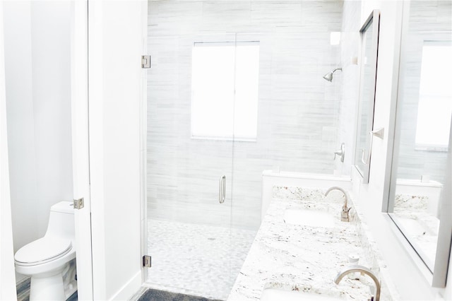 809 30th Ct E, Bradenton, FL 34208 - bathroom featuring a shower stall, toilet, a sink, and double vanity