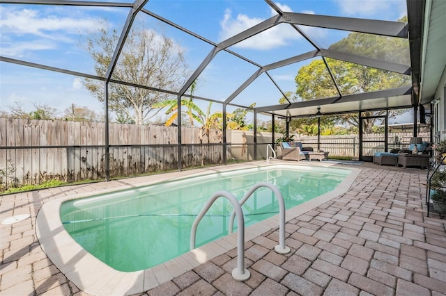 view of swimming pool with glass enclosure, a fenced backyard, a patio area, and a fenced in pool