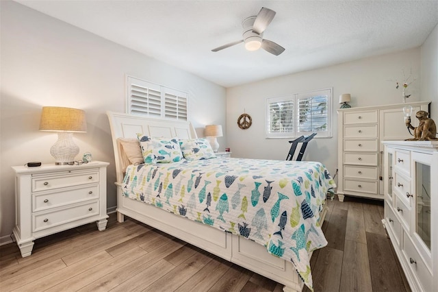 bedroom with light wood-style flooring and a ceiling fan