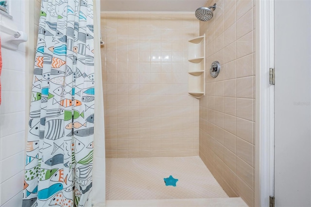 bathroom with tiled shower