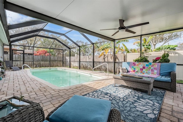 view of pool with a fenced in pool, a patio, glass enclosure, ceiling fan, and a fenced backyard