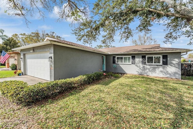 ranch-style house featuring a garage, driveway, a front lawn, and stucco siding