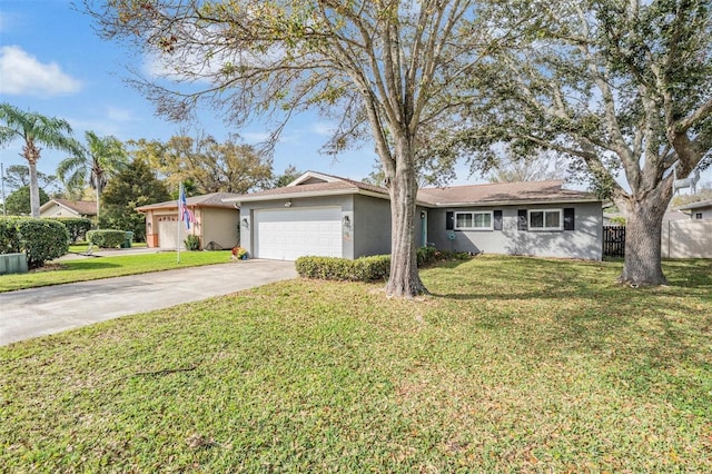 single story home featuring stucco siding, a front yard, fence, a garage, and driveway