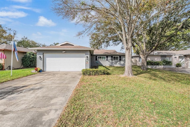 ranch-style house with a garage, a front lawn, concrete driveway, and stucco siding