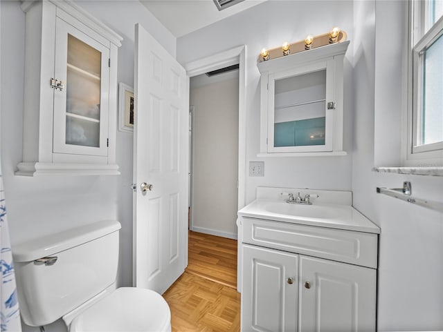 bathroom featuring toilet, visible vents, and vanity