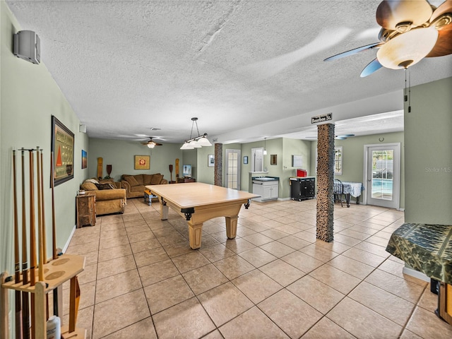 playroom with light tile patterned floors, a textured ceiling, billiards, a ceiling fan, and decorative columns