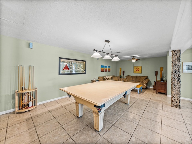 game room featuring light tile patterned floors, baseboards, a ceiling fan, and a textured ceiling