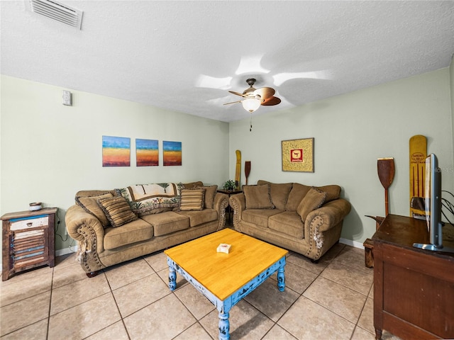 living room with light tile patterned floors, ceiling fan, a textured ceiling, and visible vents