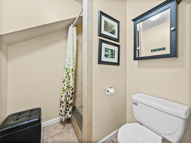 bathroom with a shower with curtain, tile patterned flooring, baseboards, and toilet