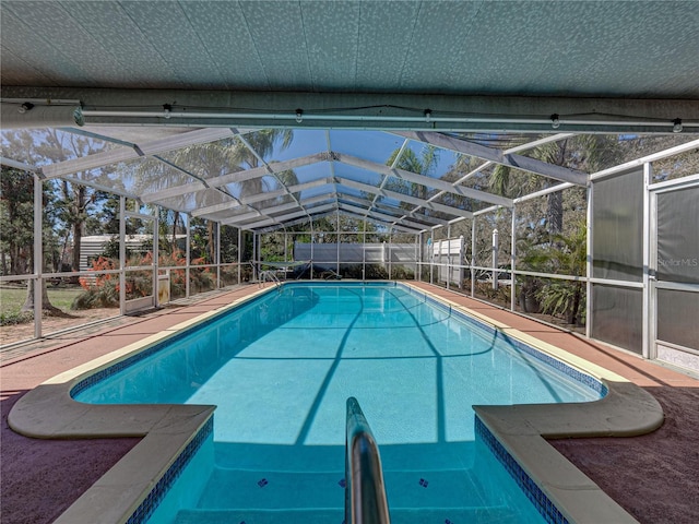 outdoor pool with a lanai and a fenced backyard