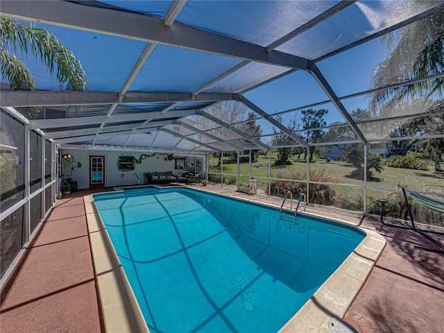 outdoor pool featuring a lanai and a patio area