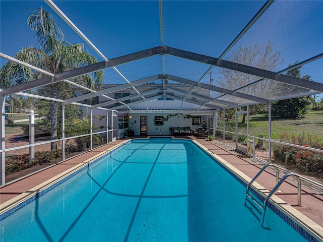 outdoor pool featuring a lanai and a patio area