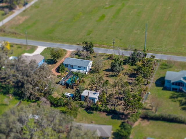 birds eye view of property with a rural view