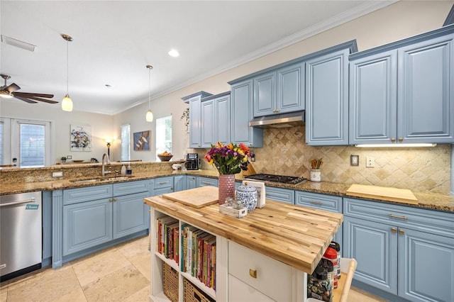 kitchen featuring a peninsula, blue cabinets, pendant lighting, and a sink