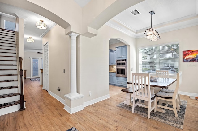 4301 W San Luis St, Tampa, FL 33629 - dining room featuring arched walkways, visible vents, light wood finished floors, decorative columns, and crown molding