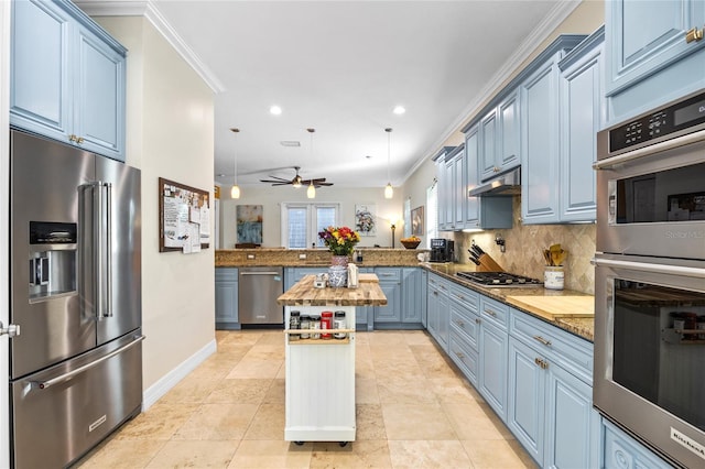 4301 W San Luis St, Tampa, FL 33629 - kitchen with a peninsula, blue cabinetry, pendant lighting, and stainless steel appliances
