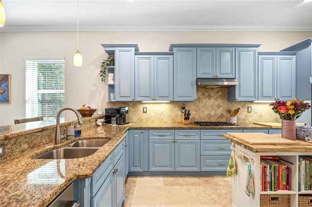 4301 W San Luis St, Tampa, FL 33629 - kitchen with light stone counters, blue cabinets, under cabinet range hood, a sink, and hanging light fixtures
