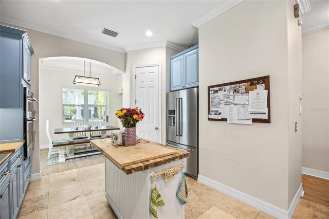 4301 W San Luis St, Tampa, FL 33629 - kitchen with appliances with stainless steel finishes, blue cabinets, visible vents, and wood counters