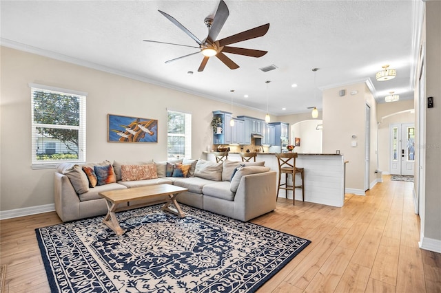 4301 W San Luis St, Tampa, FL 33629 - living area featuring light wood-type flooring, arched walkways, and ornamental molding