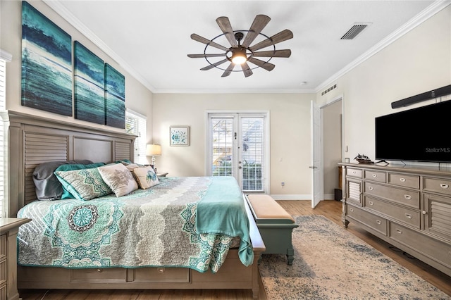 4301 W San Luis St, Tampa, FL 33629 - bedroom featuring baseboards, ornamental molding, wood finished floors, and access to exterior
