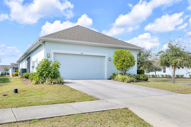 view of home's exterior featuring central air condition unit, a garage, and a yard