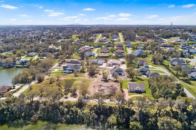 drone / aerial view with a residential view and a water view